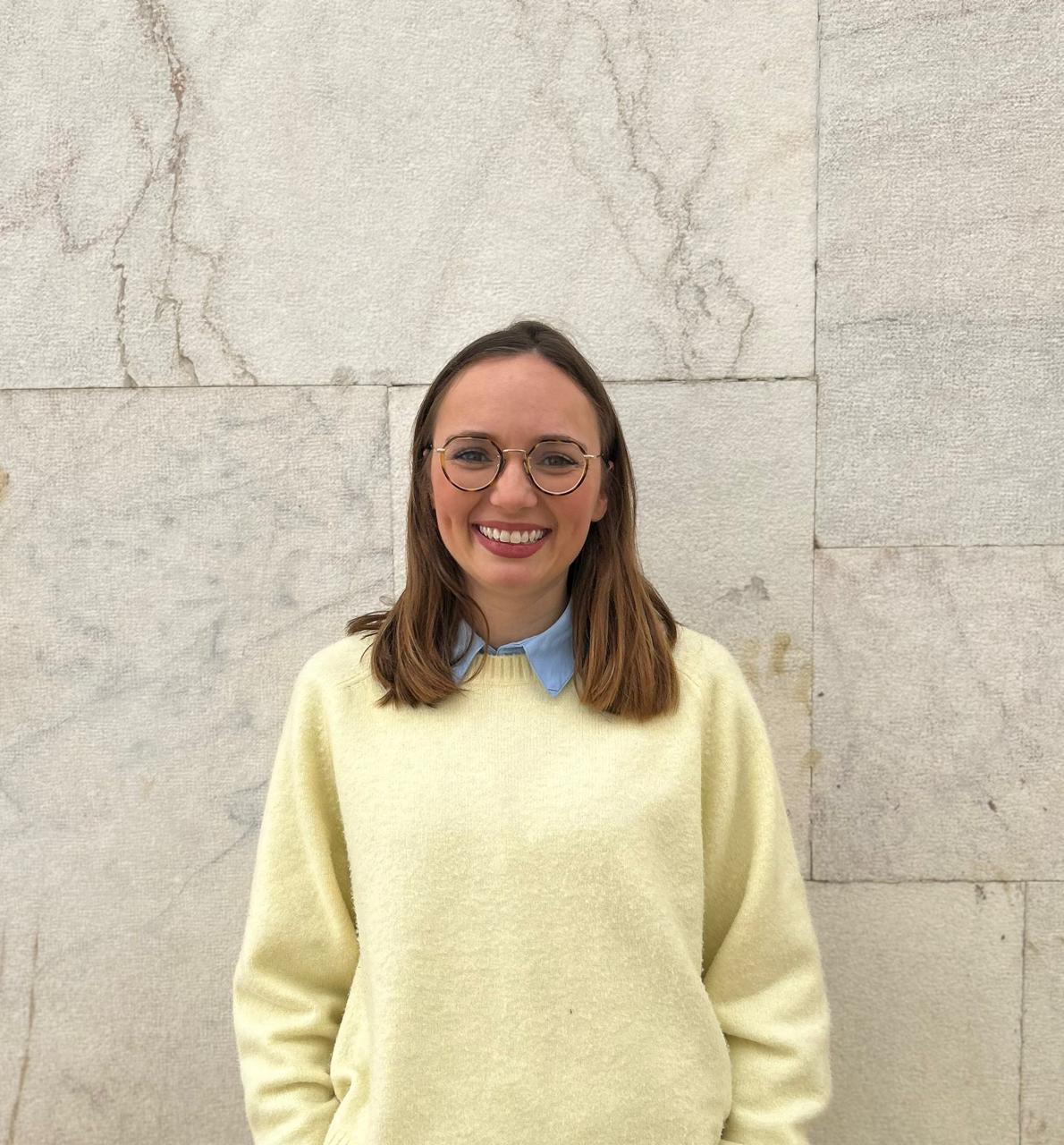 Lizzie McDowell, founder of British Primary Tutor, smiling in a pale yellow sweater